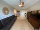 Wide view of living room with leather futon, entertainment center, and view into the dining area at 1064 N Tamiami Trl # 1219, Sarasota, FL 34236