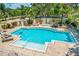 Relaxing pool area with lounge chairs, hot tub, and lush landscaping for privacy at 1064 N Tamiami Trl # 1219, Sarasota, FL 34236