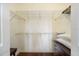 Spacious walk-in closet with custom shelving, offering ample storage solutions with dark wood floors at 1064 N Tamiami Trl # 1219, Sarasota, FL 34236