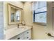 Cozy bathroom with window, bright mirror and vanity providing natural light and updated fixtures at 1672 Watermark Ne Cir, St Petersburg, FL 33702