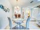 Bright dining room featuring a glass table set, modern decor, and easy access to kitchen at 1672 Watermark Ne Cir, St Petersburg, FL 33702