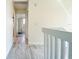 Hallway with wood-look flooring, neutral wall paint and white trim leading to other rooms at 1672 Watermark Ne Cir, St Petersburg, FL 33702