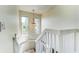 Bright staircase with elegant chandelier, complemented by large windows and natural light at 1672 Watermark Ne Cir, St Petersburg, FL 33702