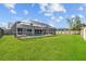 Well-maintained backyard offers a tranquil retreat with a screened-in pool and ample green space at 709 Tuscanny St, Brandon, FL 33511