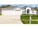 Charming single-story home featuring a well-manicured lawn and an attached three-car garage at 709 Tuscanny St, Brandon, FL 33511