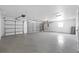 Spacious three-car garage featuring a concrete floor, ample lighting, and garage door openers at 709 Tuscanny St, Brandon, FL 33511