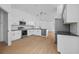 Modern kitchen with white cabinets, stainless steel appliances and pendant lighting at 709 Tuscanny St, Brandon, FL 33511