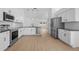 Beautiful kitchen features stainless steel appliances, white cabinets, and access to backyard at 709 Tuscanny St, Brandon, FL 33511