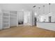 Open floor plan featuring living room and kitchen with wood flooring and modern lighting at 709 Tuscanny St, Brandon, FL 33511