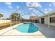 Screened-in pool features refreshing water and adjacent spa for relaxing outdoor enjoyment at 709 Tuscanny St, Brandon, FL 33511