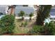 Aerial view of fenced backyard featuring grass, trees, and a small wooden deck at 8399 78Th N Ave, Seminole, FL 33777