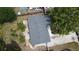 Aerial view of roof and backyard featuring a small wooden deck and grass at 8399 78Th N Ave, Seminole, FL 33777