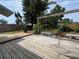 Backyard deck featuring patio set, garden, and wooden fence at 8399 78Th N Ave, Seminole, FL 33777