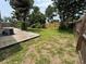 Spacious backyard featuring a wooden deck, grass, trees, and partial fencing at 8399 78Th N Ave, Seminole, FL 33777
