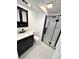 Updated bathroom featuring a dark vanity, toilet, and glass-enclosed shower with marble-style tile at 8399 78Th N Ave, Seminole, FL 33777
