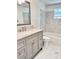 Bathroom with light grey vanity with marble countertops, and shower and bath combo at 8399 78Th N Ave, Seminole, FL 33777
