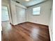 Bedroom features hardwood floors, white walls, and closet with bi-fold doors at 8399 78Th N Ave, Seminole, FL 33777