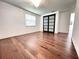 Spacious bedroom with hardwood floors, white walls, and a modern closet at 8399 78Th N Ave, Seminole, FL 33777