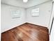 Bright bedroom features hardwood floors, two windows, and neutral walls at 8399 78Th N Ave, Seminole, FL 33777