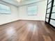 Bright bedroom featuring hardwood floors, white walls, and windows at 8399 78Th N Ave, Seminole, FL 33777