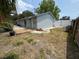 Backyard with wooden deck and lush plants next to a concrete house with a fenced yard at 8399 78Th N Ave, Seminole, FL 33777