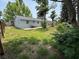 Backyard with wooden deck and lush plants next to a concrete house at 8399 78Th N Ave, Seminole, FL 33777