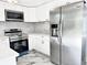 Newly renovated kitchen features white cabinets, stainless steel appliances, and marble countertops at 8399 78Th N Ave, Seminole, FL 33777