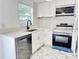 Bright kitchen with white cabinets, stainless steel appliances, and marble countertops at 8399 78Th N Ave, Seminole, FL 33777