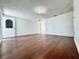 Open living room featuring hardwood floors, white walls, and front door with glass window at 8399 78Th N Ave, Seminole, FL 33777