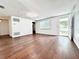 Bright living room with hardwood floors, white walls, and modern light fixture at 8399 78Th N Ave, Seminole, FL 33777