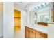Bathroom showing a walk-in closet, a light vanity with a marble counter, and tiled floors at 1408 3Rd Street E Cir, Palmetto, FL 34221
