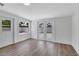 Bright bonus room featuring fresh white walls, wood-look flooring, and sliding glass doors to exterior at 3163 Key Ln, Port Charlotte, FL 33952