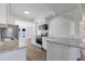 Modern kitchen featuring stainless steel appliances and a breakfast bar overlooking the dining area at 3163 Key Ln, Port Charlotte, FL 33952