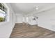 Open-concept living area showcasing wood-look flooring and a seamless transition into the updated kitchen at 3163 Key Ln, Port Charlotte, FL 33952