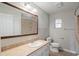 Charming bathroom features a large mirror, vanity, and neutral color palette at 408 Eunice Dr, Plant City, FL 33563