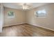 Bright bedroom with natural light, ceiling fan, and wood-look floors at 408 Eunice Dr, Plant City, FL 33563