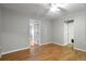 Cozy bedroom featuring hardwood floors, neutral paint, and direct access to other rooms at 408 Eunice Dr, Plant City, FL 33563