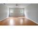 Large neutral-painted bedroom featuring hardwood floors and two windows at 408 Eunice Dr, Plant City, FL 33563