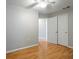 Neutral-painted bedroom featuring hardwood floors and a closet at 408 Eunice Dr, Plant City, FL 33563