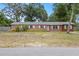 Charming single story brick home with white trim windows and spacious front yard at 408 Eunice Dr, Plant City, FL 33563