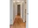 Hallway with hardwood floors, neutral paint, and white trim at 408 Eunice Dr, Plant City, FL 33563