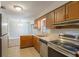 Kitchen featuring stainless steel appliances, a stainless sink and wood cabinets at 408 Eunice Dr, Plant City, FL 33563