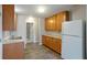 Modern eat-in kitchen features wood cabinets, new flooring, and a bright white refrigerator at 408 Eunice Dr, Plant City, FL 33563