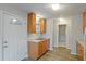 Galley kitchen featuring wood cabinets, stainless steel sink and new vinyl plank flooring at 408 Eunice Dr, Plant City, FL 33563