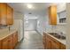 Eat-in kitchen featuring wood cabinets, stainless steel sink and white appliances at 408 Eunice Dr, Plant City, FL 33563