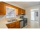 Kitchen featuring wood cabinets, a stainless sink and stainless dishwasher at 408 Eunice Dr, Plant City, FL 33563