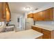 Kitchen with white countertops, stainless steel sink, wood cabinets and standard appliances at 408 Eunice Dr, Plant City, FL 33563