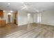 Bright, open-concept living room boasts wood floors, neutral paint, and multiple ceiling fans at 408 Eunice Dr, Plant City, FL 33563
