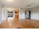 Open concept living room with hardwood floors, a ceiling fan, and stainless steel refrigerator at 408 Eunice Dr, Plant City, FL 33563