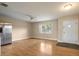 Bright living room featuring hardwood floors, ceiling fan, stainless steel refrigerator and front entrance at 408 Eunice Dr, Plant City, FL 33563